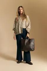 Camisa de manga larga con cuello mao y estampado paisley en tonos beige, marrón y azul sobre fondo claro. Presenta un calce holgado y puños ajustados.