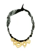 Collar con bandana estampada en blanco y negro, con dijes dorados en forma de corazón y un dije con forma de corazón y un ojo en el centro.