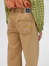 Pantalón color arena de denim con corte recto y flojo, con cintura elástica ajustable y bolsillos traseros.