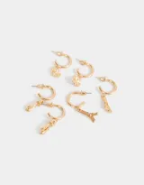 Set de tres pares de aros tipo argolla dorados con dijes colgantes: trébol de cuatro hojas, zapatillas de ballet y la Torre Eiffel.