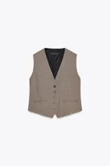 Chaleco de Zara Woman Collection con escote pico y sisa. Tiene falsos bolsillos de vivo en el delantero, tejido combinado a contraste en la espalda y cierre frontal con botones.