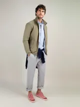 Cazadora Harrington color caqui, marca El Ganso, confeccionada en mezcla de algodón y elastano. Cuenta con cuello alto, cierre frontal con cremallera, bolsillos laterales con solapa y forro de algodón a rayas.