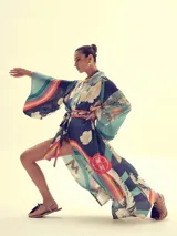 Kimono largo de seda con estampado exclusivo que combina olas japonesas y un arcoíris vibrante sobre fondo azul marino y celeste. Presenta mangas anchas estilo kimono y se ajusta con un cinturón a juego.