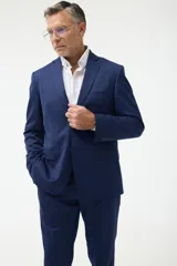 Ambo azul marino de corte clásico, compuesto por saco de dos botones con solapa de muesca, bolsillo de pecho y dos bolsillos delanteros con solapa, y pantalón de vestir con pinzas y bolsillos laterales y traseros.