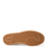 Zapatillas deportivas negras con detalles en blanco y suela color caramelo.