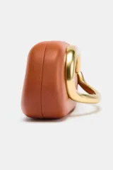 Bolso formato caja color marrón con cierre metálico dorado y asa de cadena dorada para usar como bandolera.