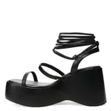 Sandalias de plataforma color nude con tiras finas y cordones para atar al tobillo.