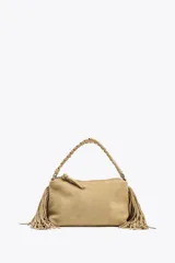 Mini bolso color beige de serraje, con flecos en los laterales, asa de mano trenzada y asa bandolera extraíble. Cierre con cremallera.