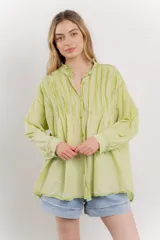 Camisa oversize de algodón color verde lima, con cuello mao con volados y pliegues verticales en el frente.