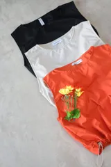 Musculosa negra de corte holgado, con cuello bote y hombros caídos.