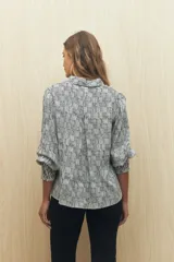 Camisa marrón con estampado animal print, cuello clásico, abotonadura frontal y mangas largas con puños elastizados.