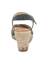 Sandalias negras con tiras cruzadas en el empeine, pulsera con hebilla al tobillo y plataforma de yute.