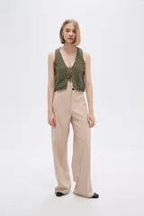 Pantalón de poliéster color beige, de corte recto y tiro alto.