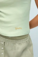 Musculosa de algodón peruano color lila, de calce ajustado, con escote en "U" y largo a la cadera. Presenta detalle de bordado marcario metálico en el frente.