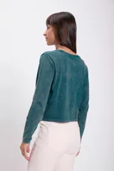 Remera verde de manga larga con cuello redondo y corte holgado.