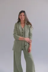 Blazer verde seco de lino, con corte entallado, solapas clásicas y cierre frontal con botones.