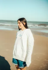 Hoodie blanco con capucha y cordones ajustables, con logo estampado en el pecho.