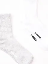 Pack de dos pares de medias de caña corta, un par color gris y otro par color blanco, con logo de la marca en el tobillo.