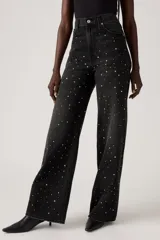 Pantalón de jean negro de corte wide leg con tachas plateadas.