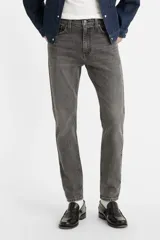Pantalón de jean gris oscuro, corte skinny, tiro medio y confeccionado en tejido rígido.