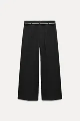 Pantalón culotte color crema, de tiro medio y pierna ancha. Incluye cinturón marrón con hebilla metálica.