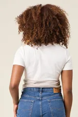 Remera blanca de algodón con mangas cortas y cuello redondo. Estampado frontal con el texto 'SANDKNIT SINCE 1981' en color gris. Diseño con efecto degradado en la parte inferior.