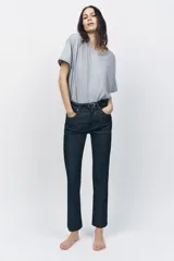 Pantalón de jean azul oscuro, de tiro alto, corte slim fit y bootcut.