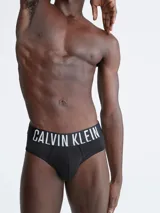 Pack de tres slips negros Calvin Klein de corte clásico, con cintura elástica con el logo de la marca en blanco y rojo.