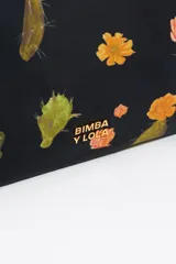 Neceser mediano de nylon negro con estampado de cactus y flores naranjas. Tiene cierre de cremallera dorada, logo metálico de la marca y bolsillo interior.