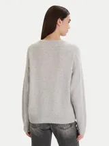 Sweater negro de calce relajado con cuello redondo y mangas largas, con terminaciones acanaladas en puños y ruedo.