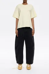 Pantalón vaquero de corte barrel, largo tobillero, tiro medio, color negro, con cierre frontal de botón y cremallera, bolsillos delanteros en costura, bolsillos de plastrón en la parte posterior y costadillos laterales.