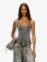 Body de tirantes color gris oscuro con efecto lavado o 'acid wash', corte ajustado y escote redondo. Presenta un parche rectangular con texto en la zona del pecho.