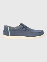 Alpargata negra con cordones elásticos y suela blanca con textura.