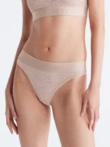 Colaless color beige con encaje floral semitransparente y cintura elástica con logo Calvin Klein.