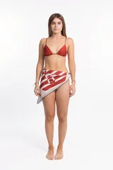 Pareo de playa con estampado de rayas rojas y blancas y logo circular.