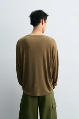 Camiseta verde militar de manga larga, corte holgado y cuello redondo.