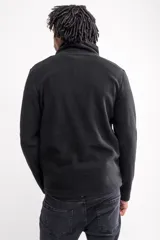 Buzo micropolar azul marino con cuello alto y medio cierre.