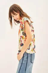 Camisa de corte amplio con cuello camisero y botones a tono.