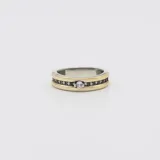 Anillo de plata y oro con circonia central y circonias pequeñas en los laterales.
