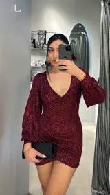 Minivestido de fiesta color bordó con brillos, escote en V y mangas largas abullonadas.