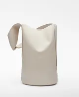 Bolso tipo tote color crudo, con correa de hombro ancha y bolsillo interno con cierre.