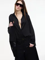 Camisa negra de viscosa con botones frontales y mangas largas.