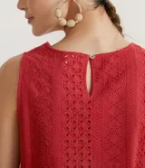 Blusa musculosa color ladrillo en tejido de laise texturizado, con cuello redondo, tirantes anchos y aplicación de canutillos de madera en la barra.