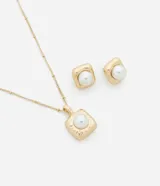 Conjunto de collar y aros dorados con colgante y aros cuadrados con perlas artificiales. El collar tiene una cadena de eslabones con pequeñas bolitas. Los aros son tipo botón con cierre a rosca.