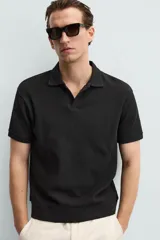 Polo azul marino de punto con textura acanalada vertical, corte regular fit, cuello solapa con abertura frontal y mangas cortas.