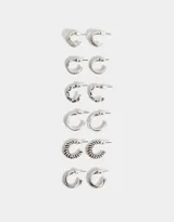 Set de seis pares de aros argolla en distintos modelos con baño de plata y acabado envejecido.