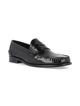 Zapato mocasín de cuero negro con detalle de antifaz y suela plana.