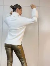 Sweater blanco de cuello alto con puños de piel sintética.