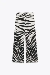 Pantalón de tiro medio con estampado animal cebra, corte palazzo y cierre lateral con cremallera oculta.
