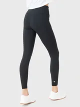 Calza larga negra de lycra con cintura alta y logo estampado en la pierna.